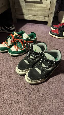 Men’s Nikes, and one pair of orange new balance