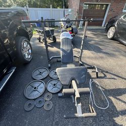 Home gym weight set with adjustable bench, olympic barbell and weights plus more fitness equipment 