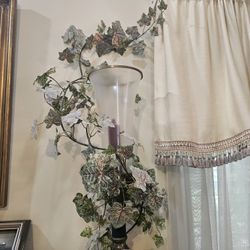 Candles with flower around the glass