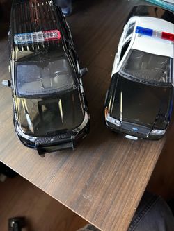 Two toy police car models