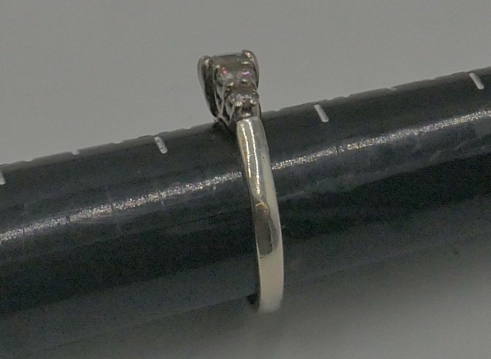 14KT WHITE GOLD ANNIVERSARY BAND SIZE 7.5 3.8 GRAMS WITH 5 DIAMONDS APPROXIMATE CENTER ROUND DIAMOND 0.30 0.35PTS SI2 H; 2 SIDE DIAMONDS 0.16 0.18