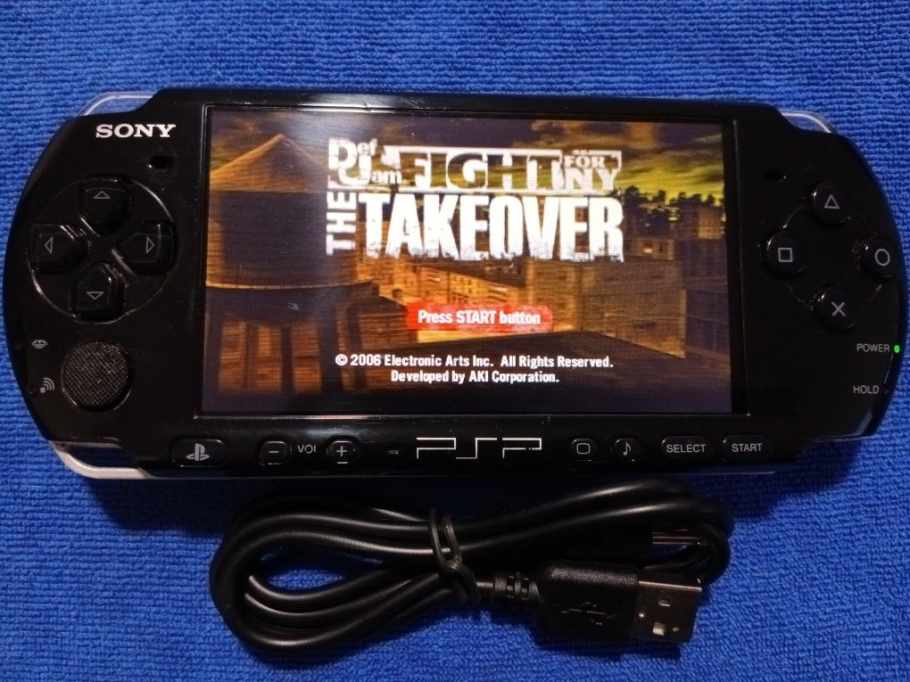 PSP 3000 With Charger And Games Inside. Works