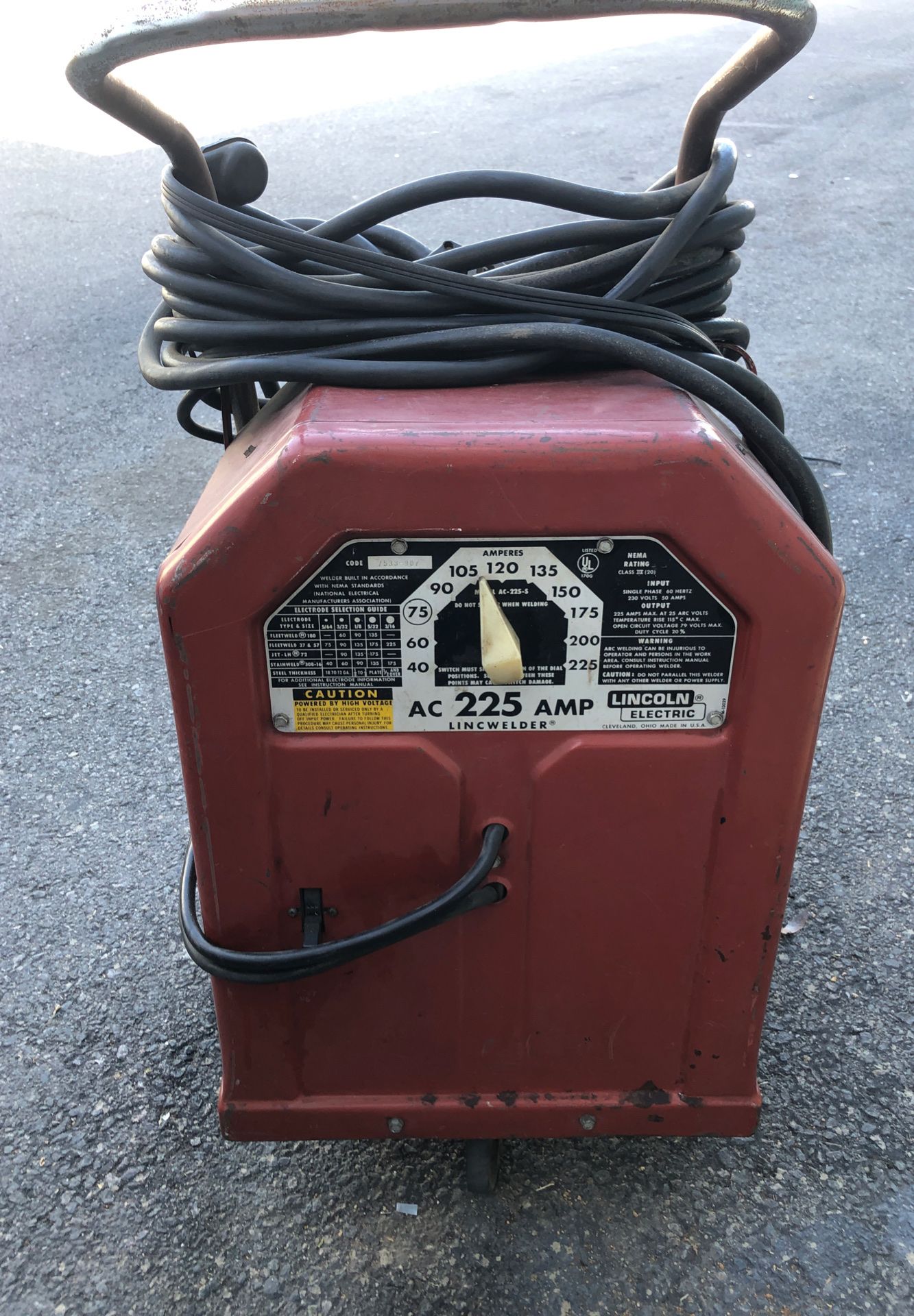 Lincoln Arc welder on cart with very long cord, 220v plug adapters, extra twist rod holder, and tons of welding rods