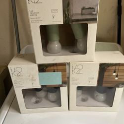  3 Project 62 brand LED pendant lights, specifically a 2-pack of battery-operated lights designed for indoor or outdoor use