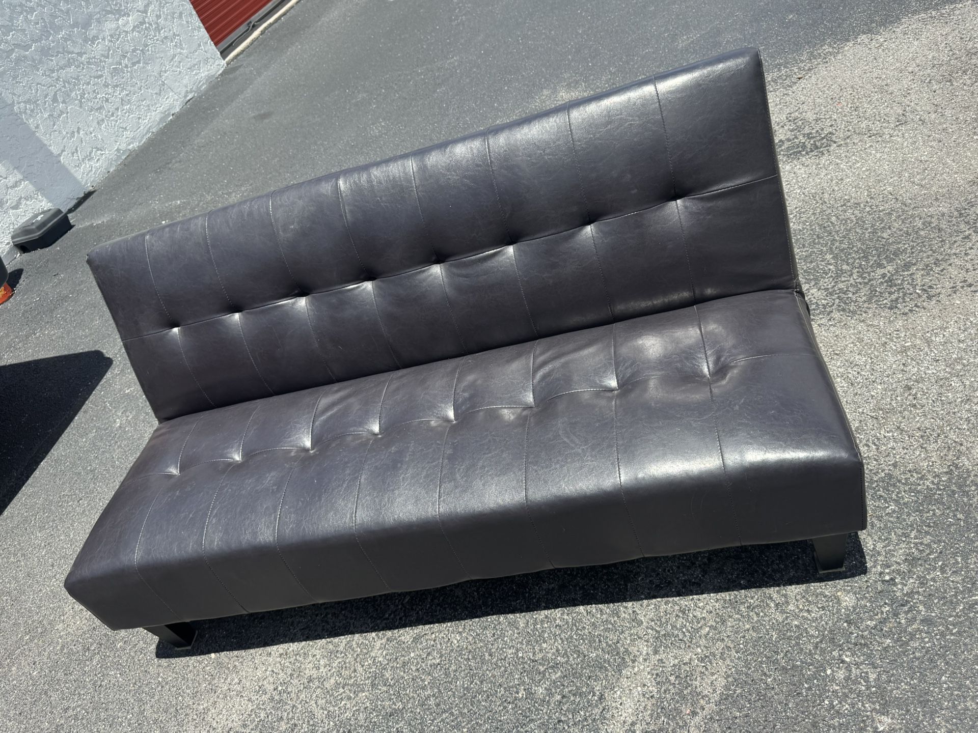 faux leather futon sofa bed (Delivery Available)