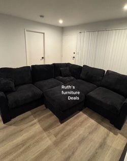 Stylish black sectional sofa with ottoman new in box