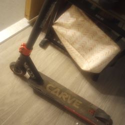 Madd Gear Carve Pro freestyle stunt scooter in black and red.