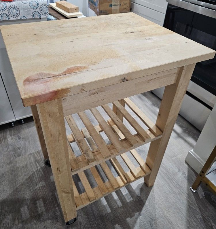 Sturdy and functional butcher block rack with wheels and 2 shelves, barely used.