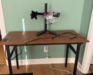 Desk with power strip and dual monitor stand