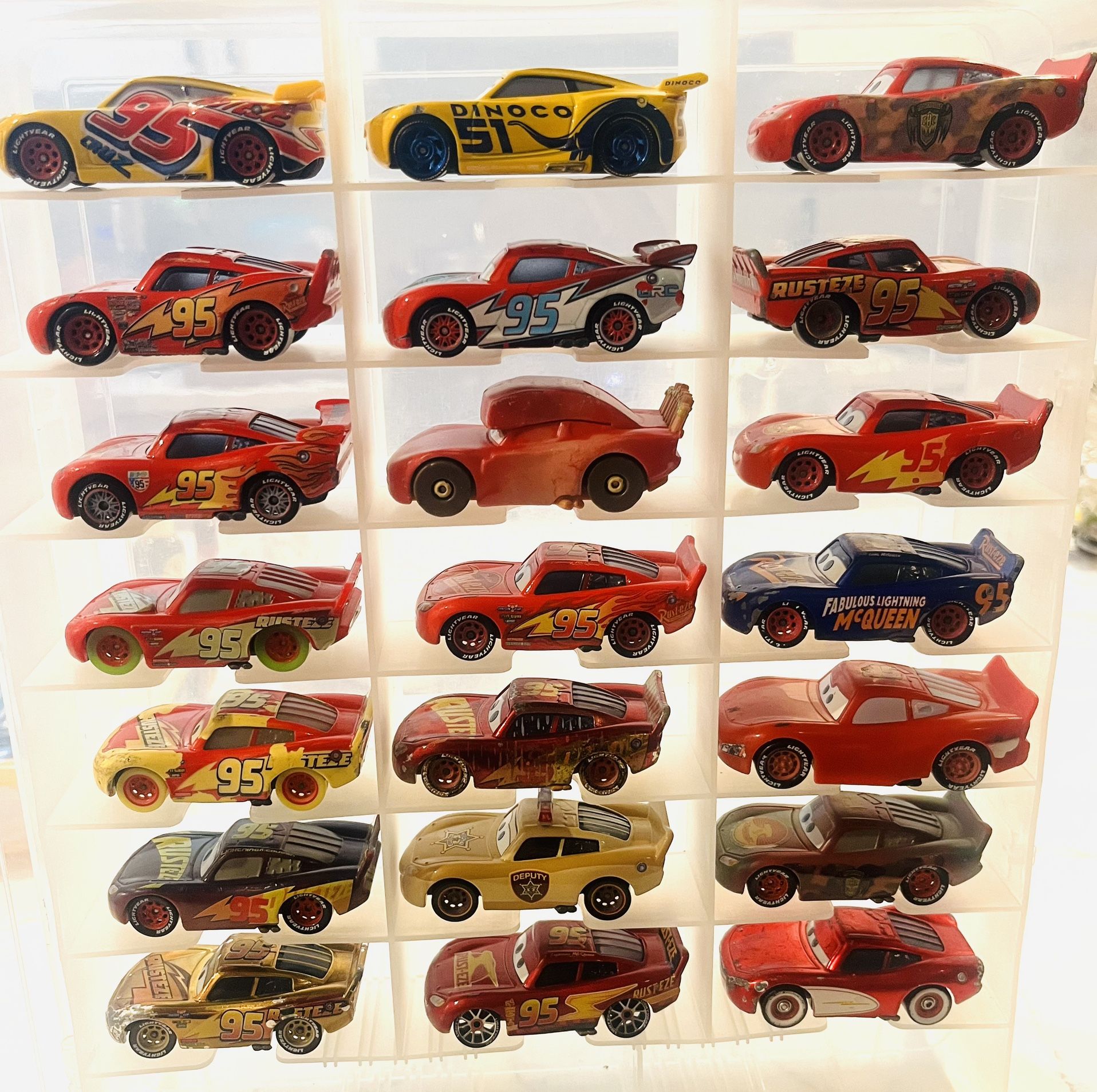 lot of 21 collection features different versions of Lightning McQueen as seen throughout the Cars franchise, including the classic "Rust-eze" look and