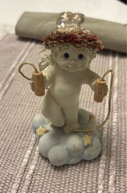 Charming vintage figurine is “Jumping for joy “holding a golden rope from Dreamsicles collection.