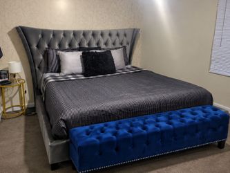 Gray Velvet Tufted Wingback King Bed Frame with blue ottoman