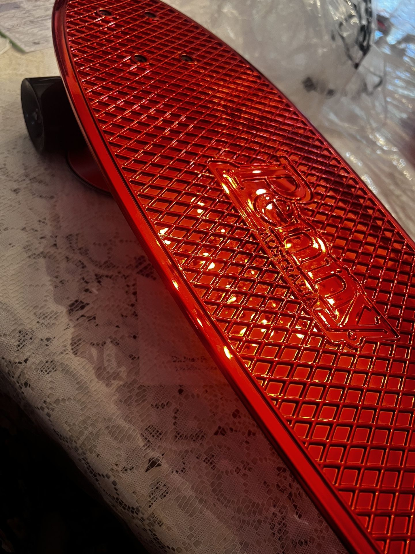 Red skateboard, Penny “Nickel”.