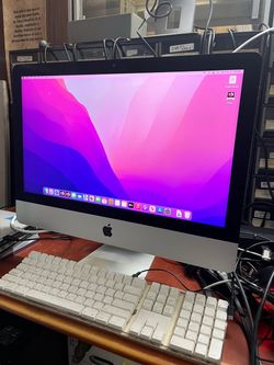 Apple iMac retina 4k 21.5-inch Late 2015 with a slim aluminum body and built-in display. Powered on and running macOS Monterey. 16GB RAM 256GB SSD NO