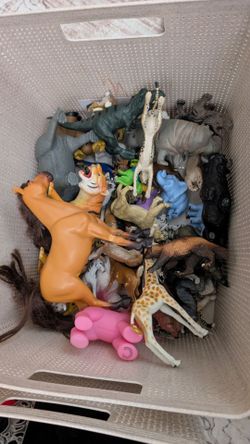 Large basket of animal and dinosaur figurines