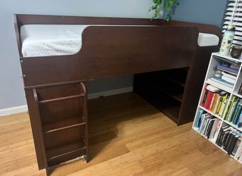 Raised twin bed with dresser and bookshelf