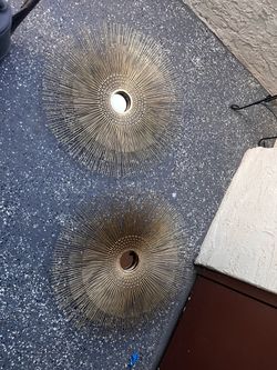 Pair of gold sunburst wall art