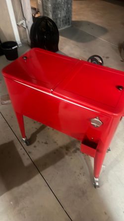 Ice cooler on wheels bottle opener, and bottle cap dispense