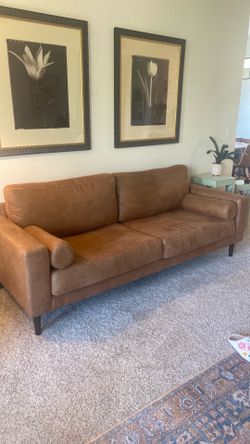 Small leather sofa, small dining table with four chairs, two small chairs.