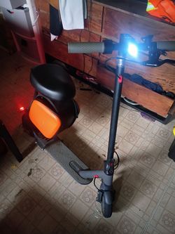 Electric scooter with seat/storage bag