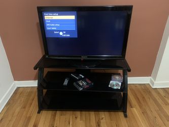 36 inch Viera Panasonic LCD tv with a black three tier glass stand