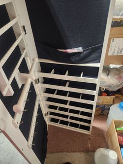 Jewelry cabinet white 48.5high 14.75 wide 4" deepstands on floor just anchor to wall or hang on wall the is in bottom compartment has a little ding on