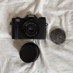 Black digital camera + macro lens 