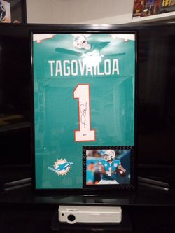 TUA TAGOVAILOA, WITH THE MIAMI DOLPHINS, STITCHED, SIGNED FRAMED JERSEY WITH COA.
