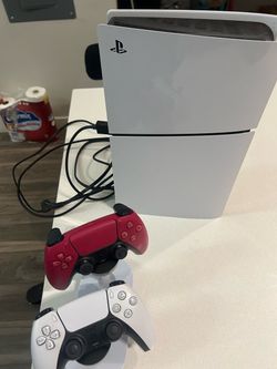 Slim PlayStation five console with two remotes and stand