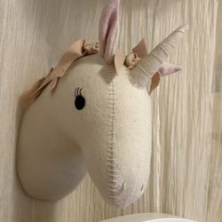 Soft felt unicorn plush wall mount from the Pillowfort brand at Target. This cream-colored decorative piece has pink 