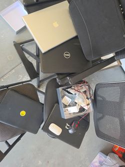 Apple MacBook, a Dell laptop, and two additional black laptops.
