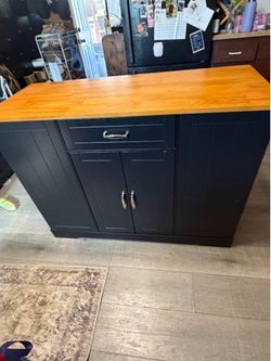 black kitchen storage cabinet and island