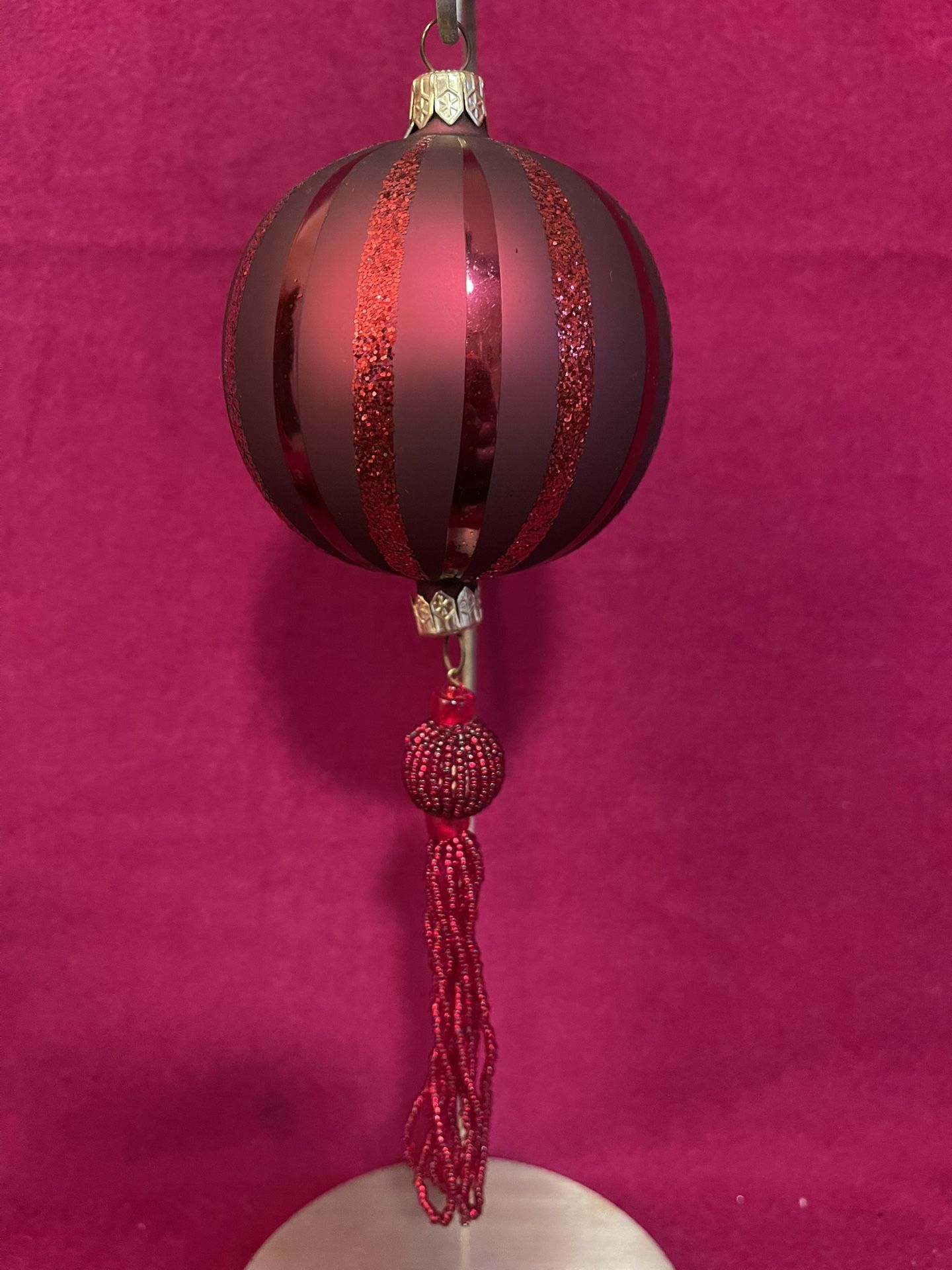 Vintage glass Christmas ornament with glitter stripes and a beaded tassel