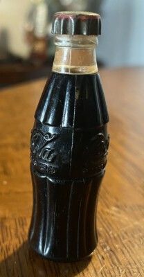 This is a vintage 1950s Coca-Cola bottle lighter, a collectible advertising item. 
