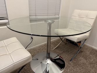 Glass dining table with white leather chairs