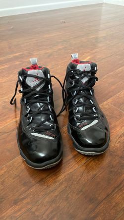 Size 14 Nike Air Jordan Jumpman Team Elite 1 sneakers feature a black patent leather upper with red accents.