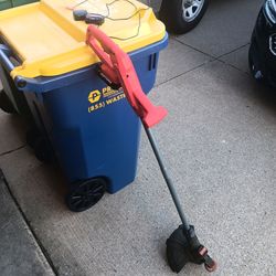 Cordless Craftsman V20 string trimmer and edger has a red and black plastic body with a grey metal shaft. This tool is powered by a V20 lithium-ion ba