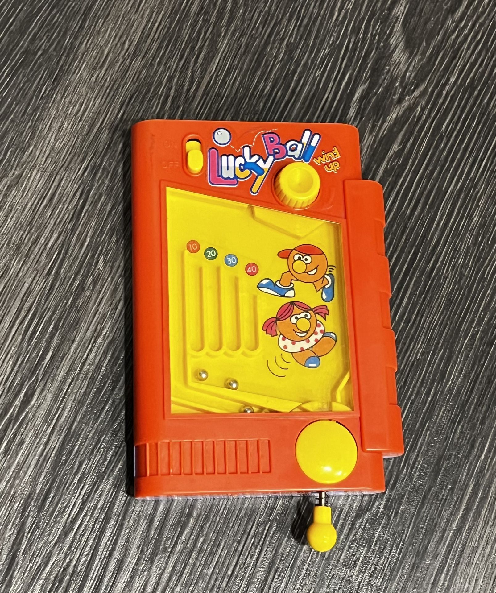 vintage Lucky Ball hand held pinball wind up skill game in the red box