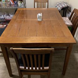 Solid oak table with 6 chairs and one leaf good elbow room.