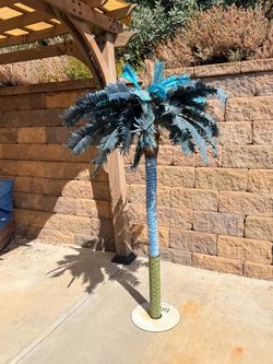 Colorful metal palm tree for outdoor decor.