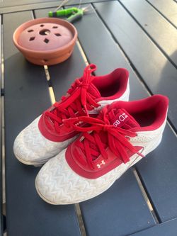 Children's red and white soccer shoes, in excellent condition.