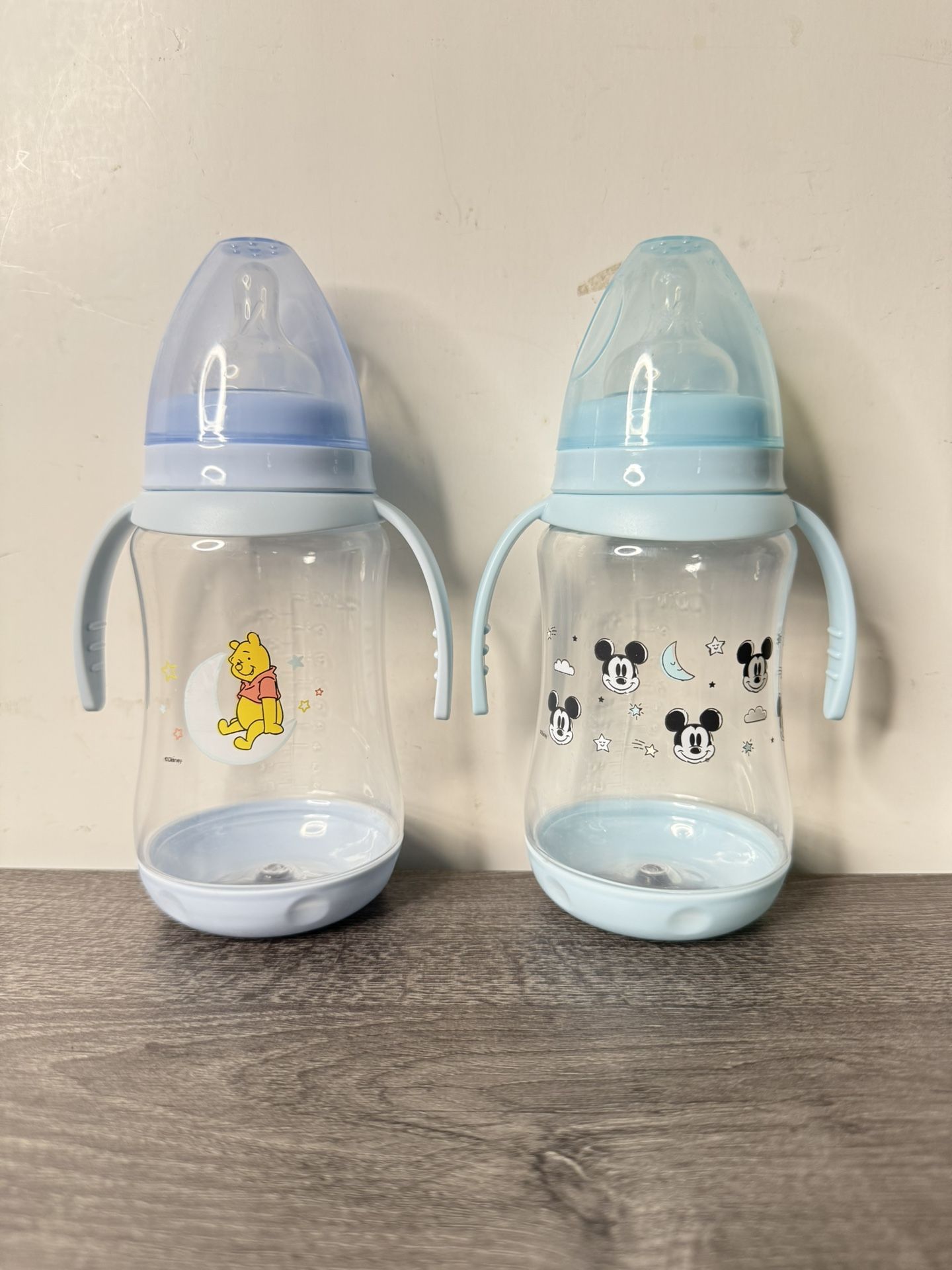 Disney 2 Pack 10 Ounce Baby Bottles with Character Prints and Colored Covers with Double Handle - BPA Free and Easy to Clean