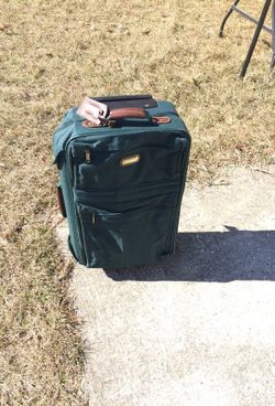 Green jaguar suit case on wheels 15 by 23 with key and lock