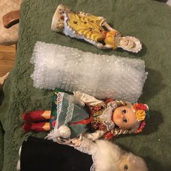 random pile of porcelain and plastic dolls