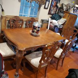 6 chairs 1 leg is broken on the arm has leaf in the middle to expand