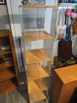 Acrylic and natural wood 5 tiered roller bookcase.
