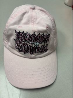 Light Pink baseball cap featuring embroidered gothic-style text that reads "BROOKS & DUNN" along with a cow skull graphic  Good condition ready to shi