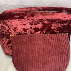Burgundy and yellow velvet makeup bag with a large main compartment.