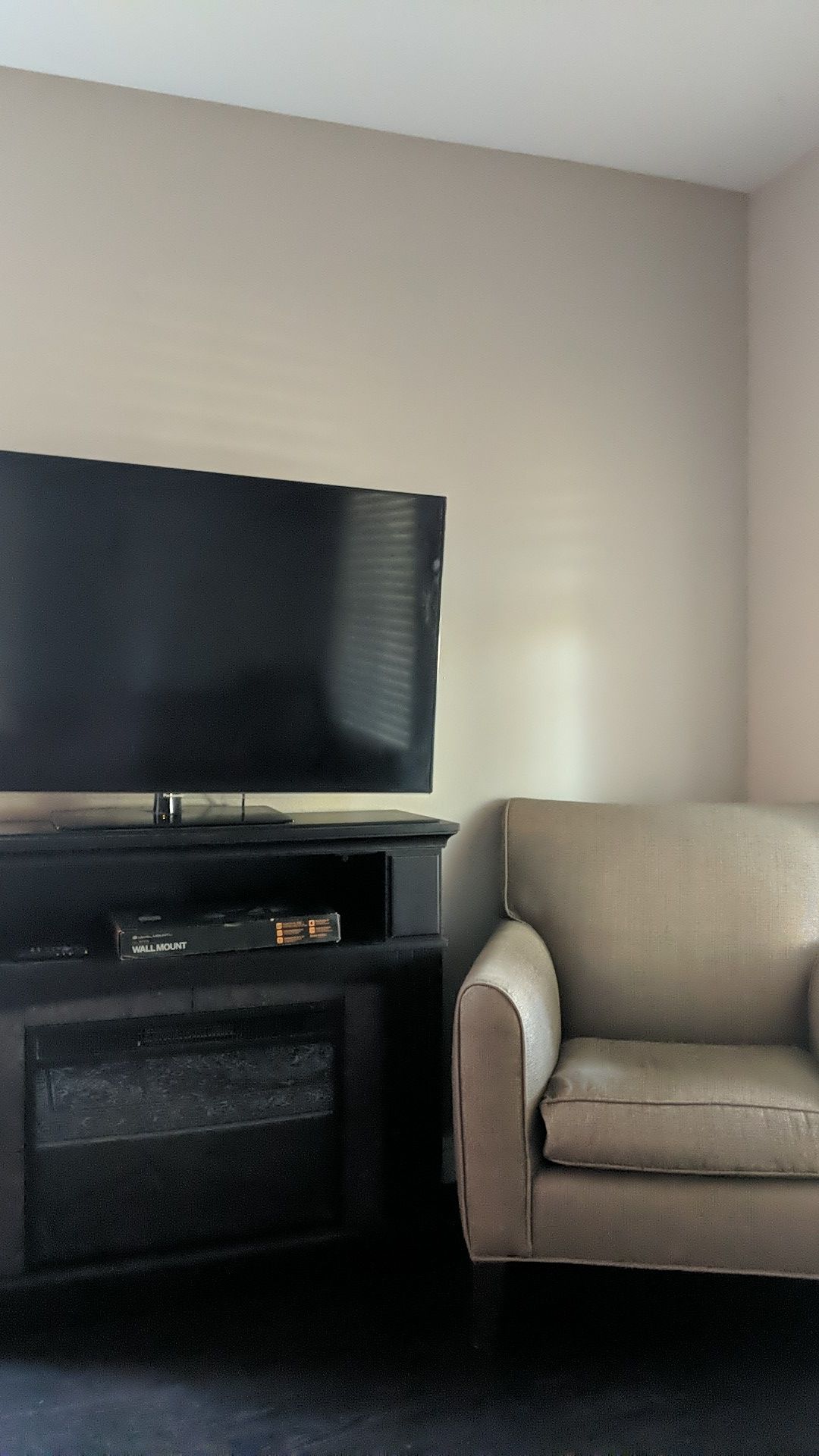 1080p Smart T.V., Wall Mount, Fireplace, & Armchair