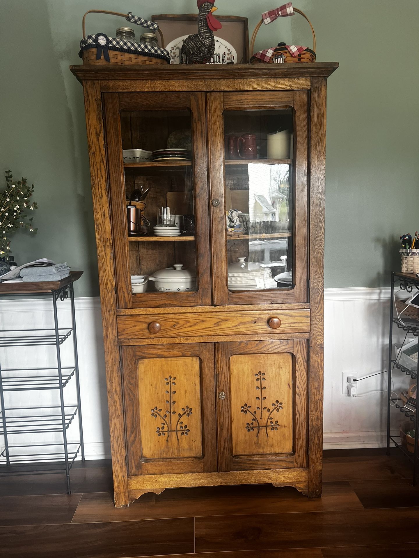 Antique oak cupboard with glass doors and flower carvings